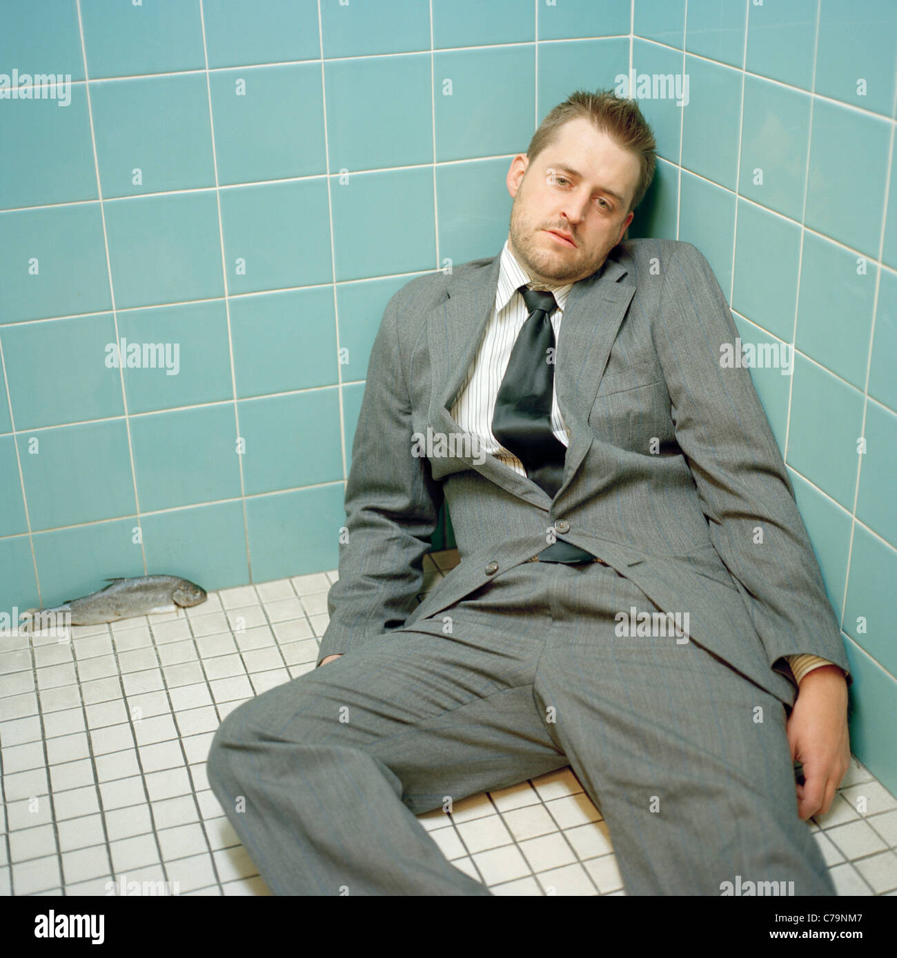 USA, Utah, Salt Lake City, Mid adult man wearing suit lying down at