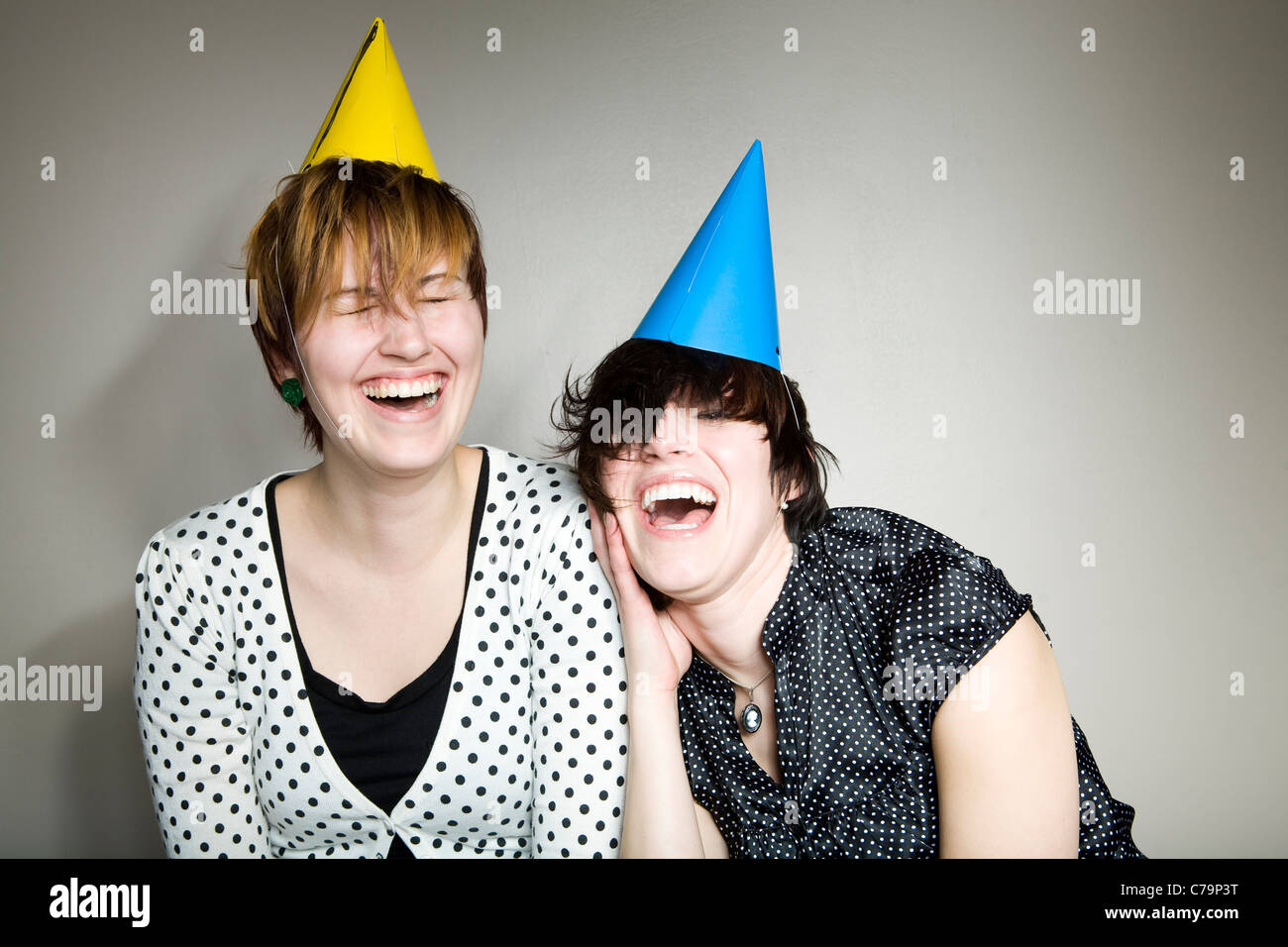 Studio shot of two women wearing party hats Stock Photo