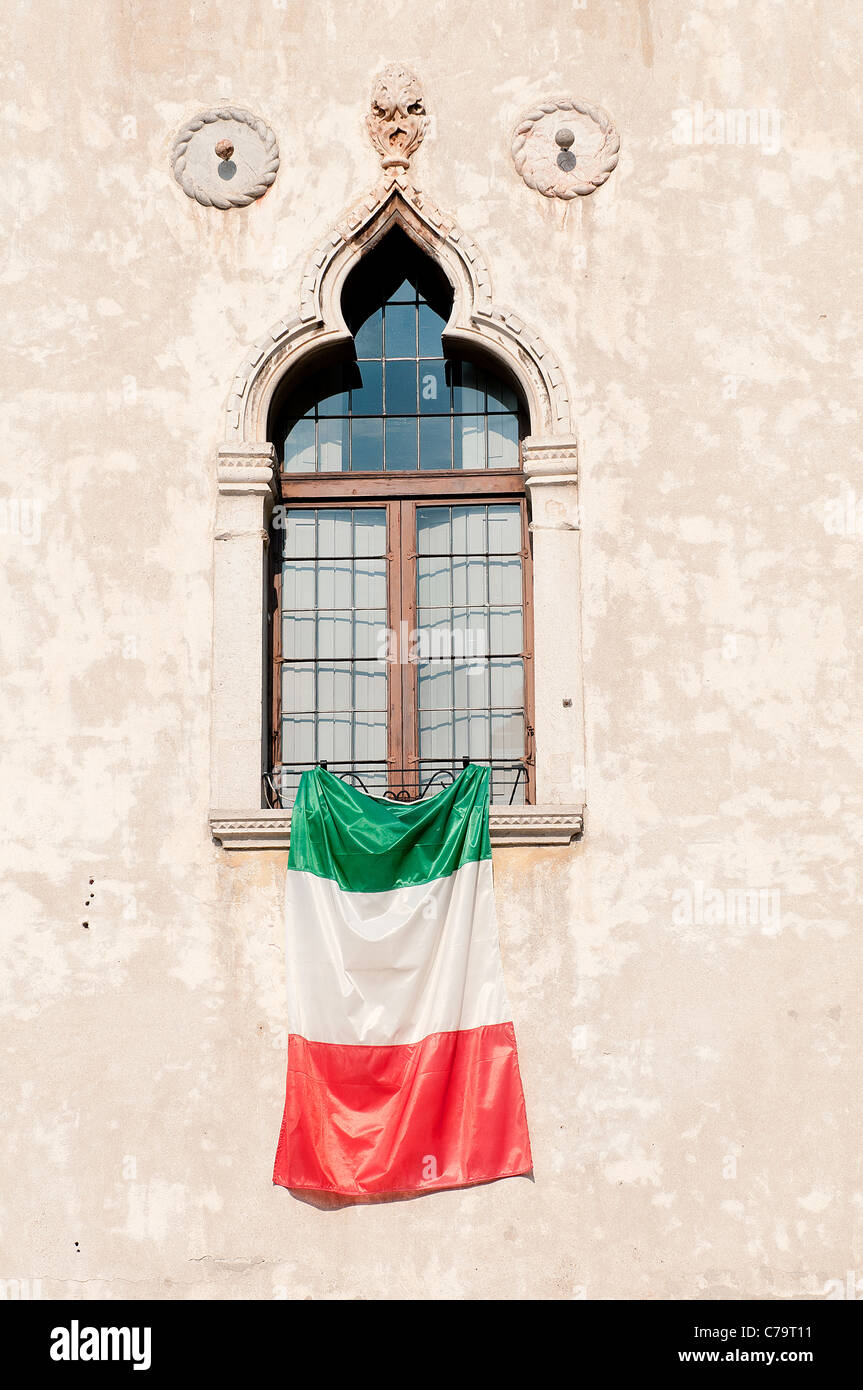 the Italian flag displayed on a window Stock Photo