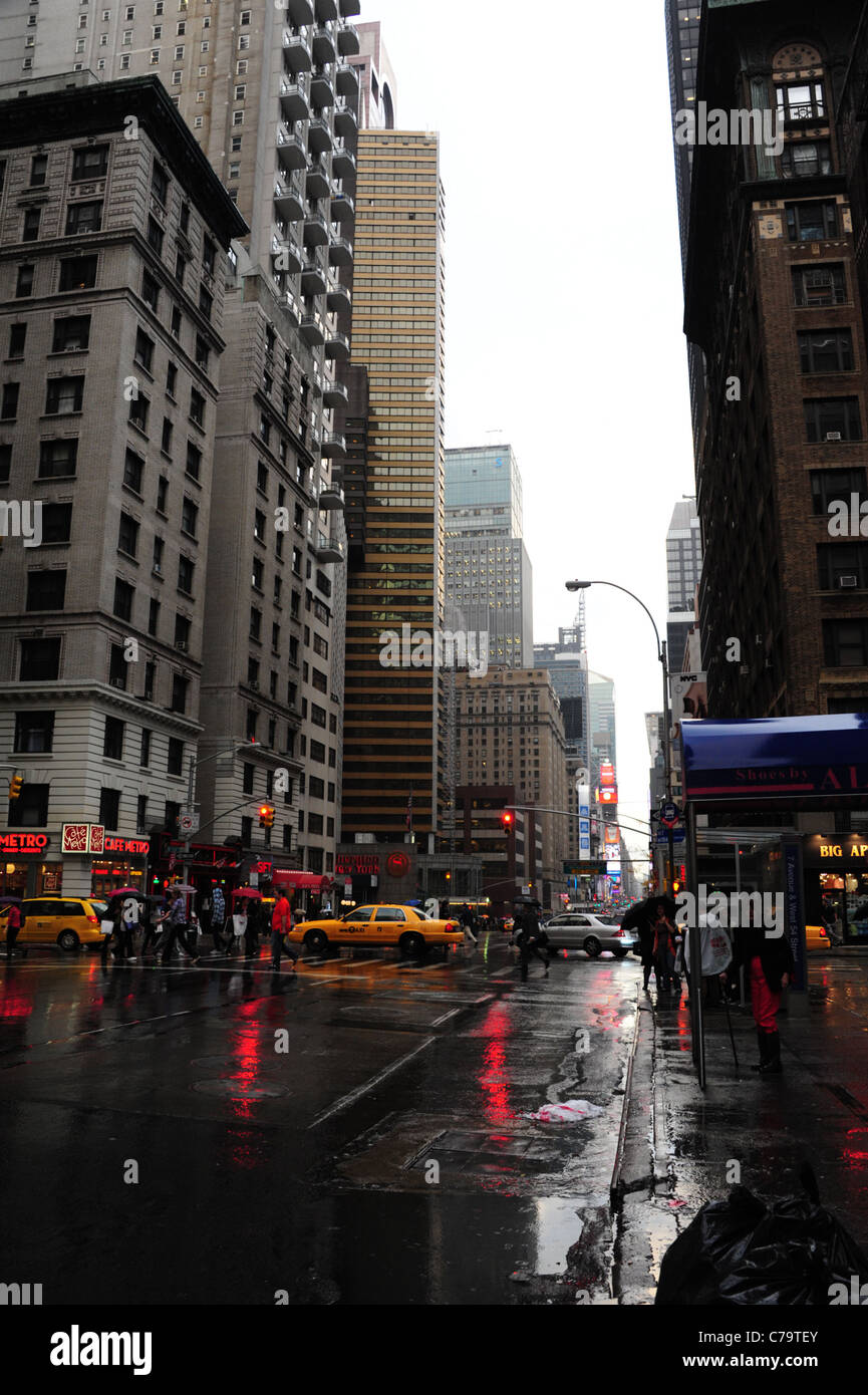 Portrait umbrella people taxis red traffic lights rainy wet tarmac 7th