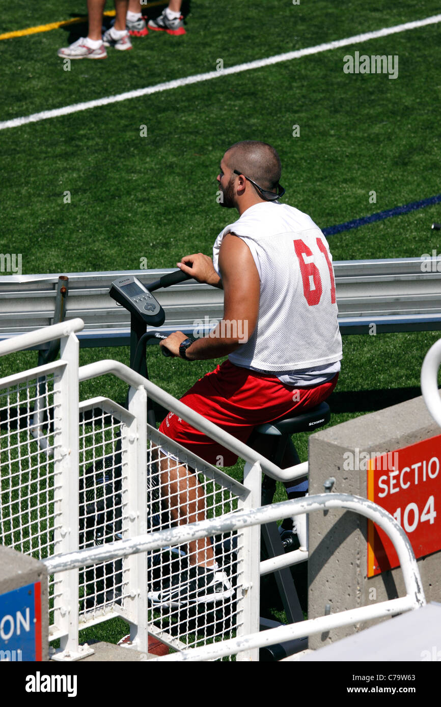 Injured football player rehabbing injury on exercise bike Stony Brook