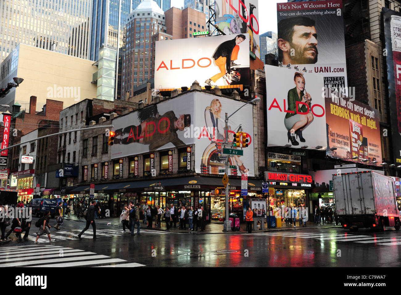 Rain view neon lights, illuminated shops, people, billboard advertisement, corner 7th Avenue West 48th Street, New York City, US Stock Photo