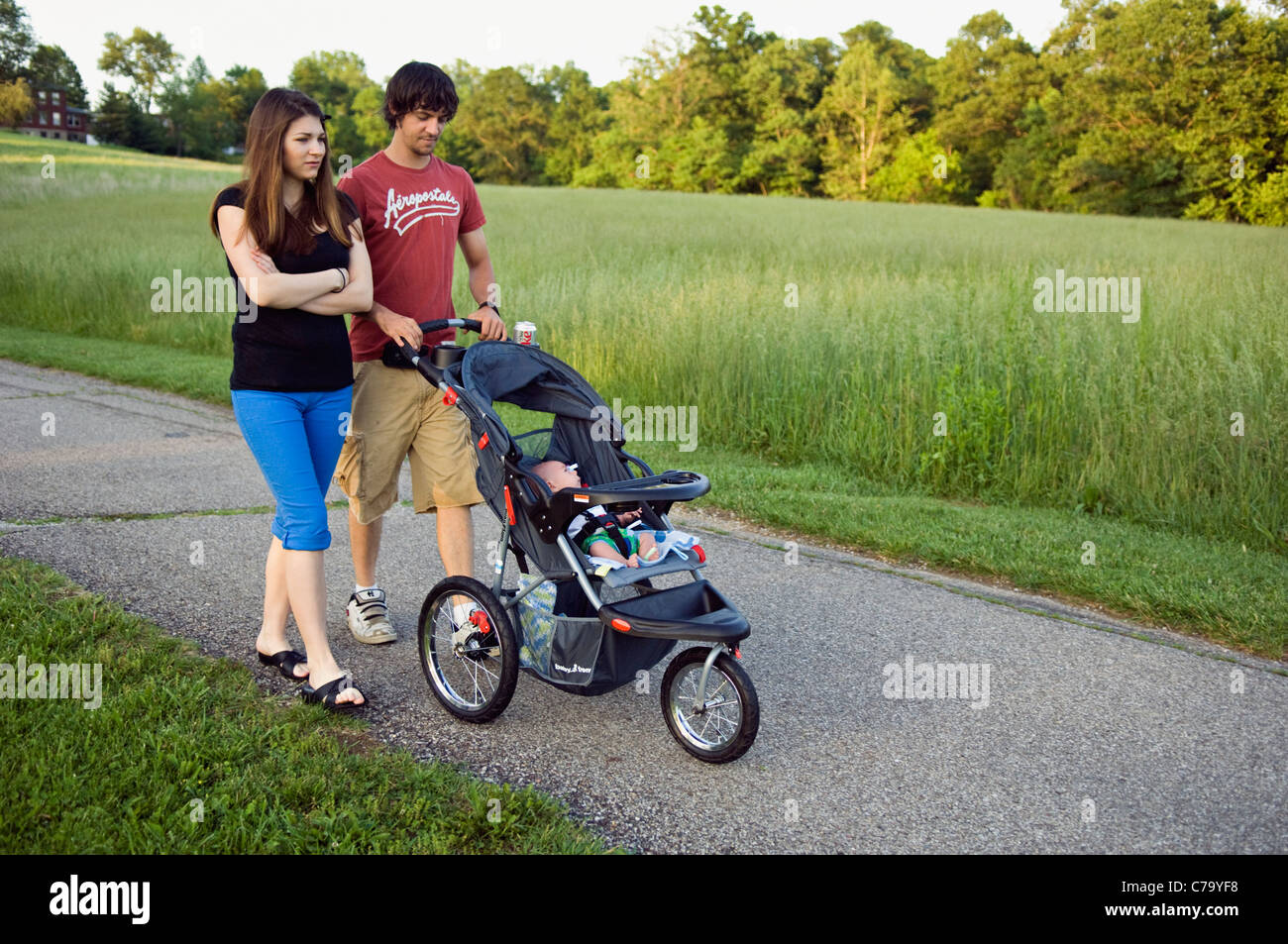 Young Couple Strolling their New Baby in Floyd County, Indiana Stock Photo