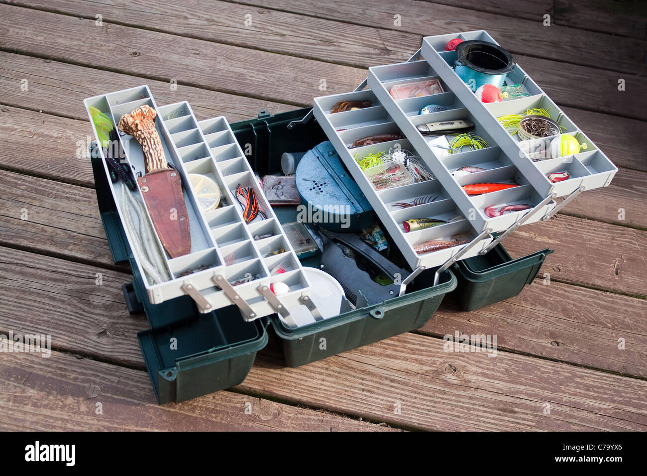 https://c8.alamy.com/comp/C79YX6/a-large-fishermans-tackle-box-fully-stocked-with-lures-and-gear-for-C79YX6.jpg