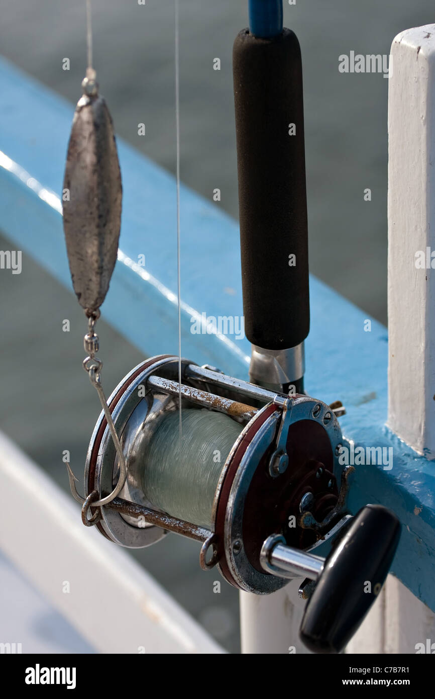Close up detail of a bait casting deep sea fishing reel and rod