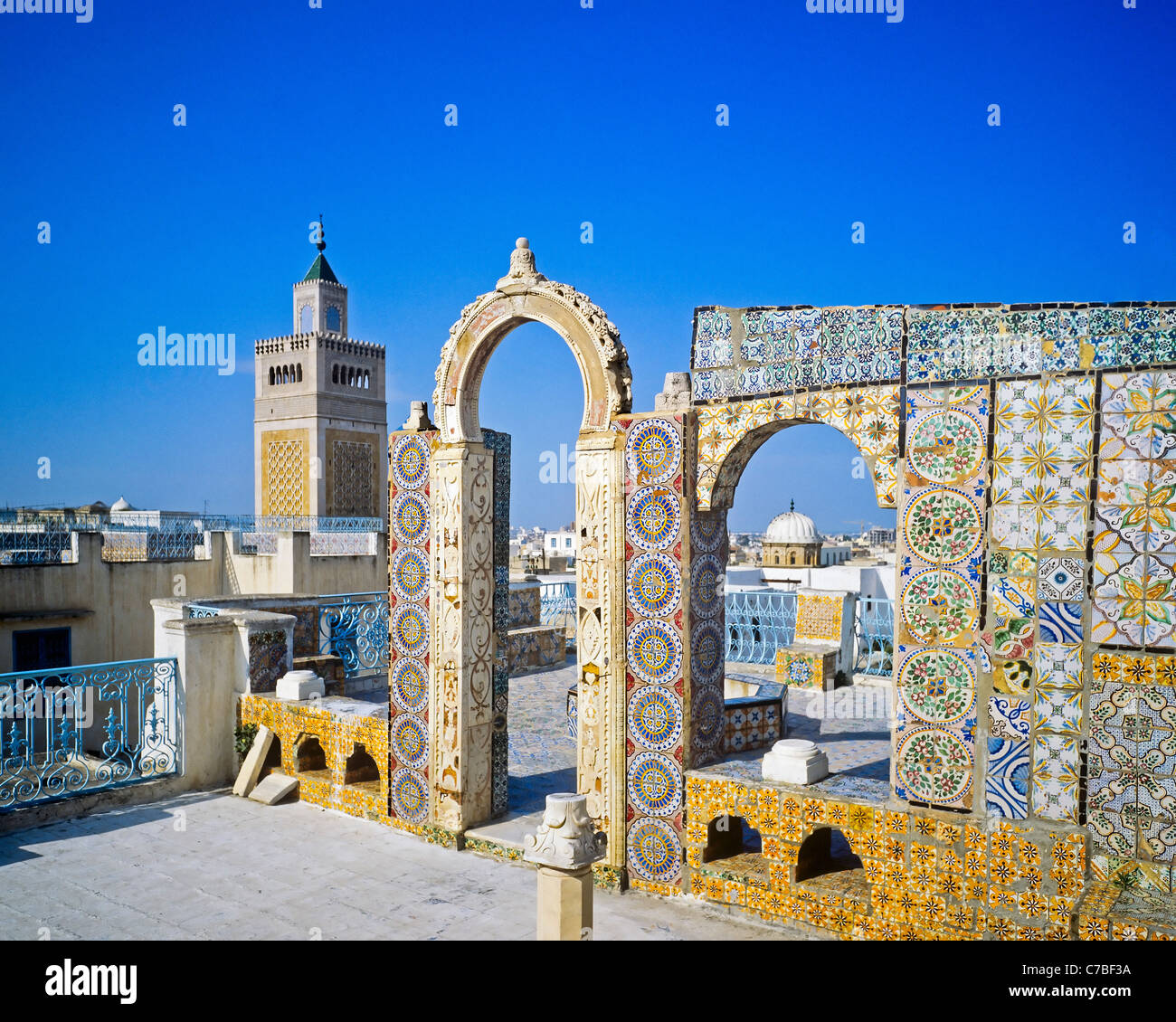 Tunis, Tunisia, North Africa, old Medina, Palais de l'Orient, Oriental palace roof terrace decorated with mosaics, Zitouna mosque minaret, Stock Photo