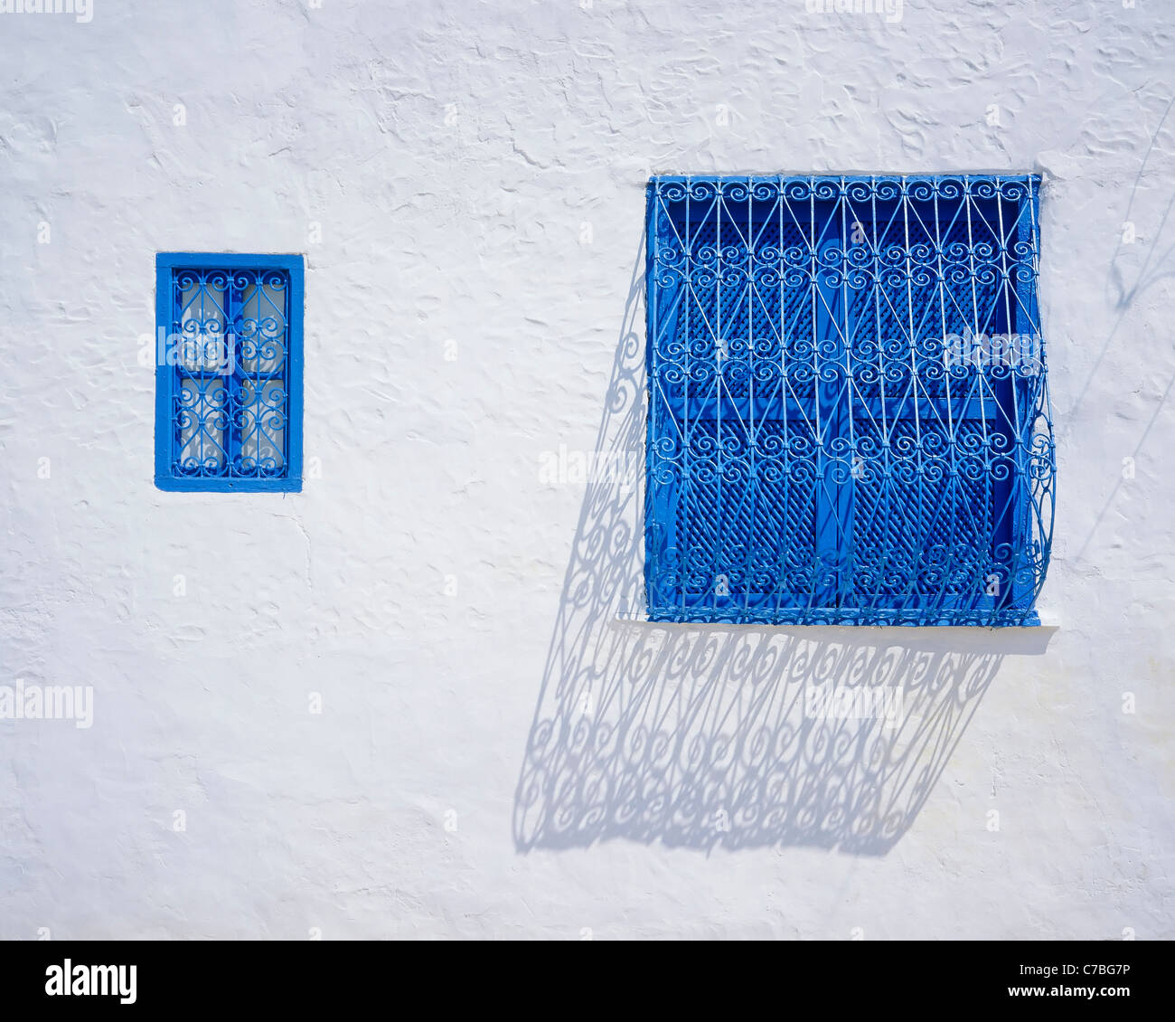 Sidi Bou Said, Tunisia, North Africa, traditional blue wrought iron window grilles, white wall, Stock Photo