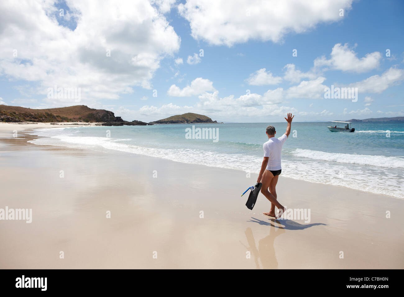 Tourist with snorkelling gear on Middle Island beach Island next to Great Keppel Island Great Barrier Reef Marine Park UNESCO Wo Stock Photo