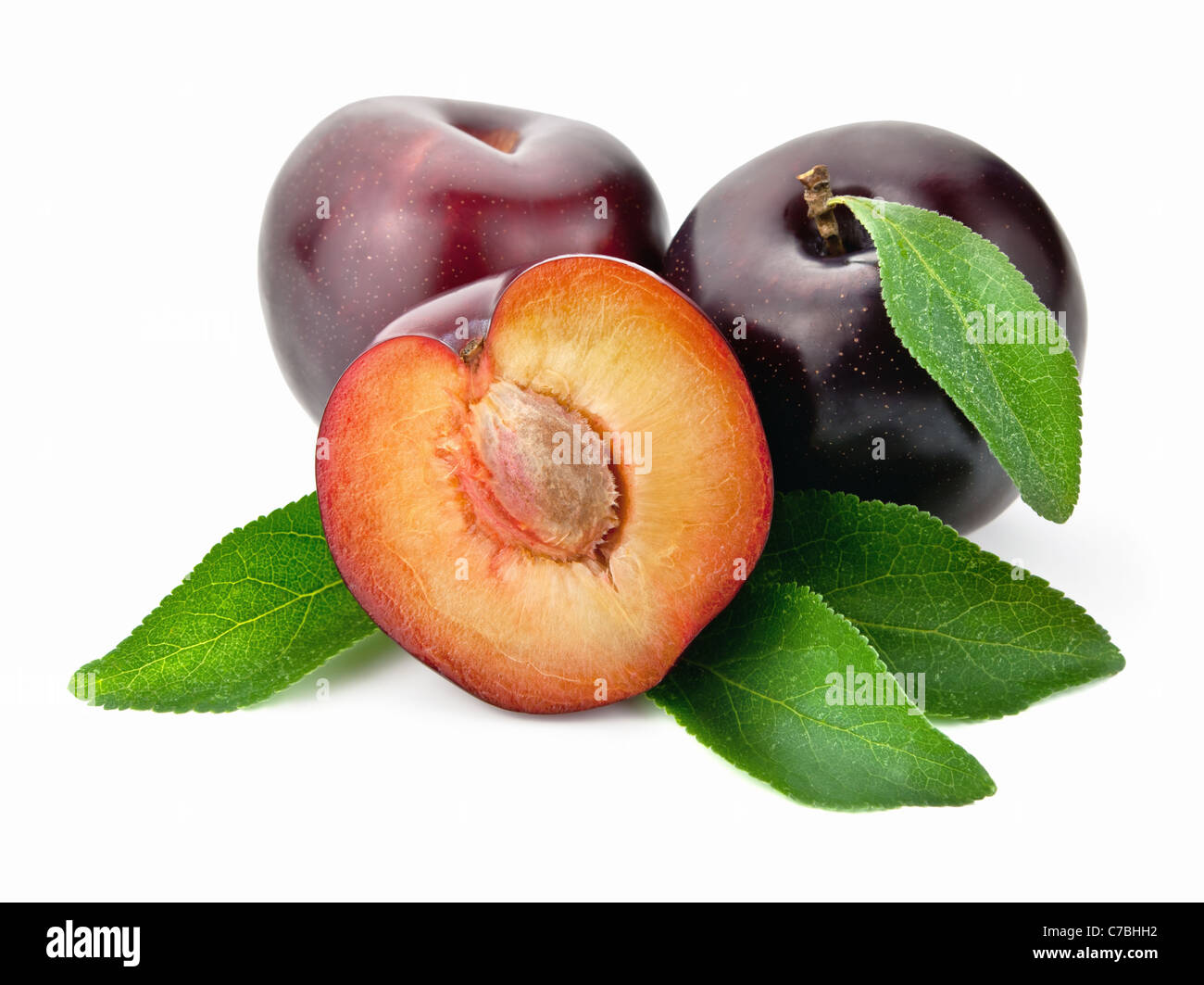 Plums with leaves on white background Stock Photo