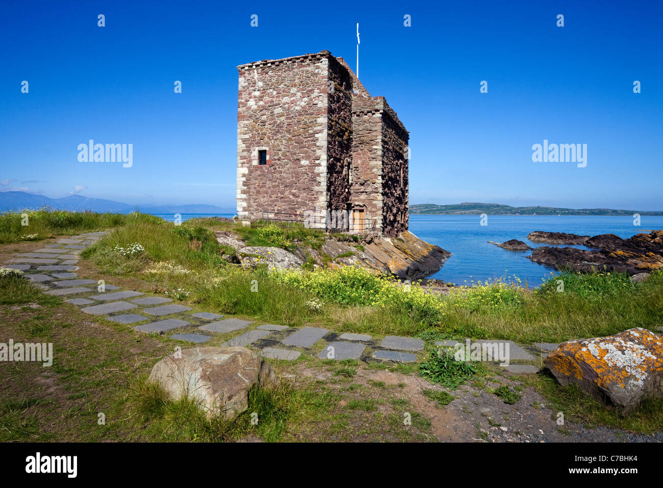 Portencross castle, with a view across the Firth of Clyde to the Island of Arran and Little Cumbrae, Ayrshire, Scotland Stock Photo