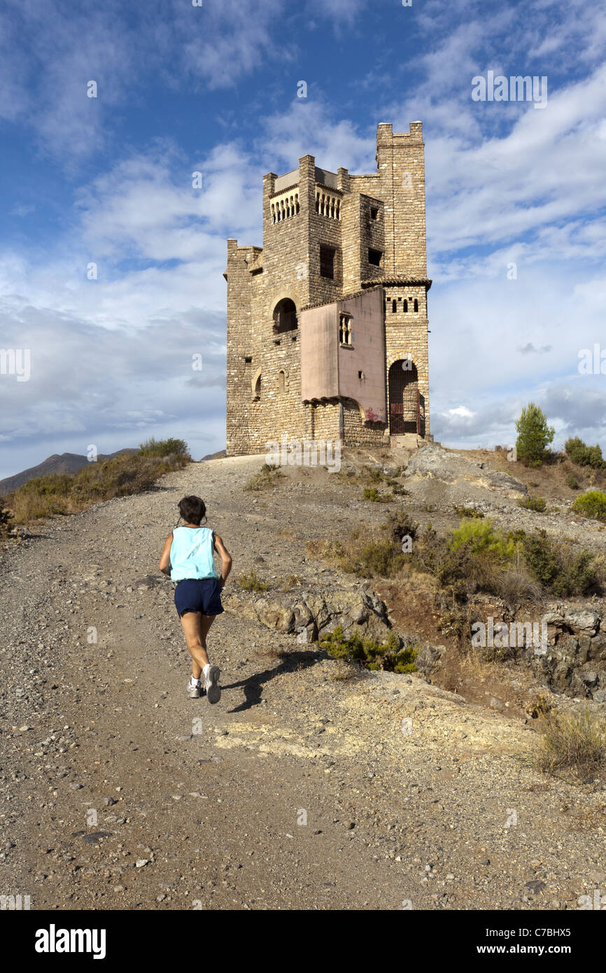 Runner near the water tower at the La Mota abandoned building development, just outside Alhaurin El Grande, Andalucia, Stock Photo