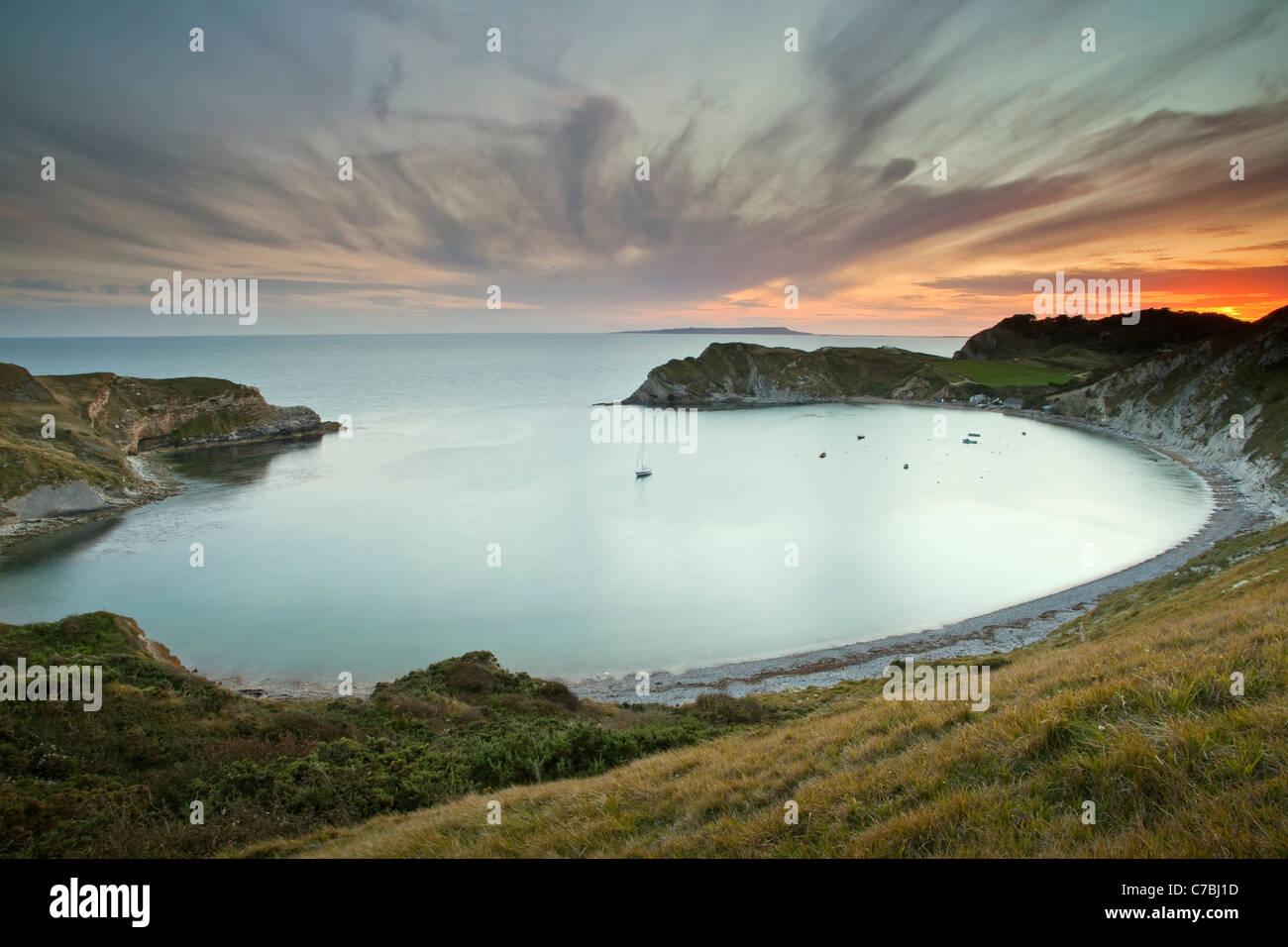 A View Of Lulworth Cove Part Of The Jurassic Coast In Dorset At Sunset A View Of Lulworth Cove Part Of The Jurassic Coast In Dorset At Sunset
