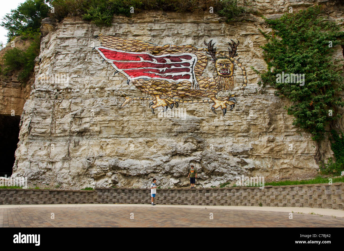 Boys looking at the painting of the Piasa bird on the cliffs beside the Mississippi River near Alton, Illinois Stock Photo