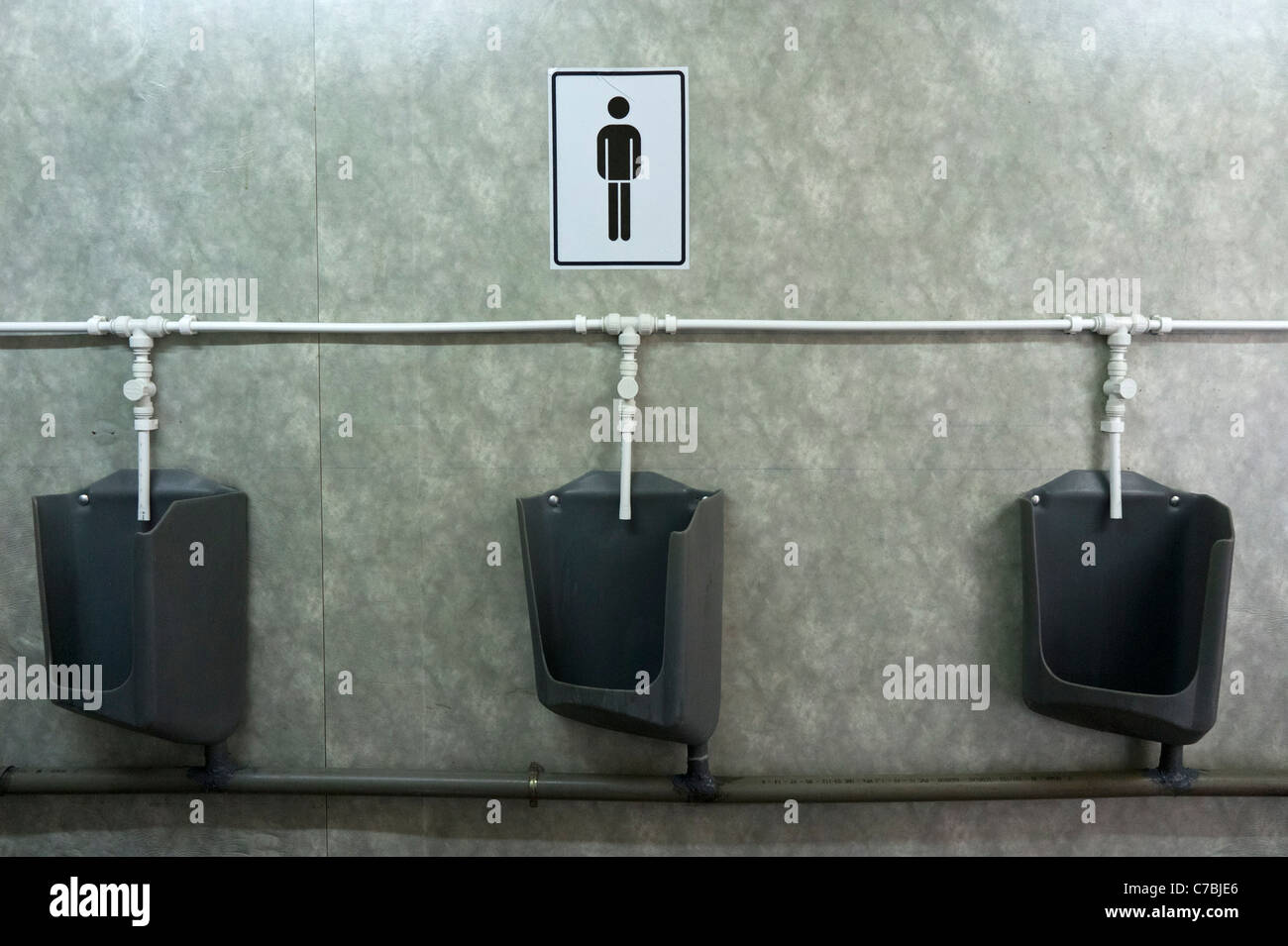 Row of urinals in a public restroom Stock Photo Alamy