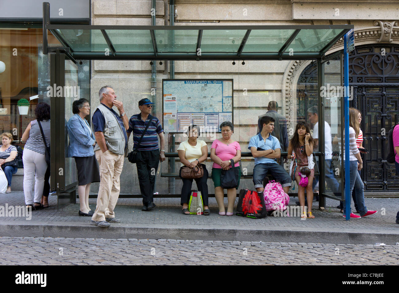 People waiting for bus at a bus stop, Porto, Portugal, Europe Stock Photo
