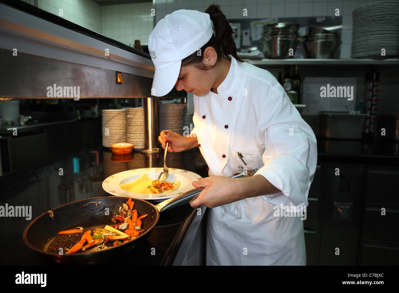 Cook arranging food on a plate Stock Photo Alamy