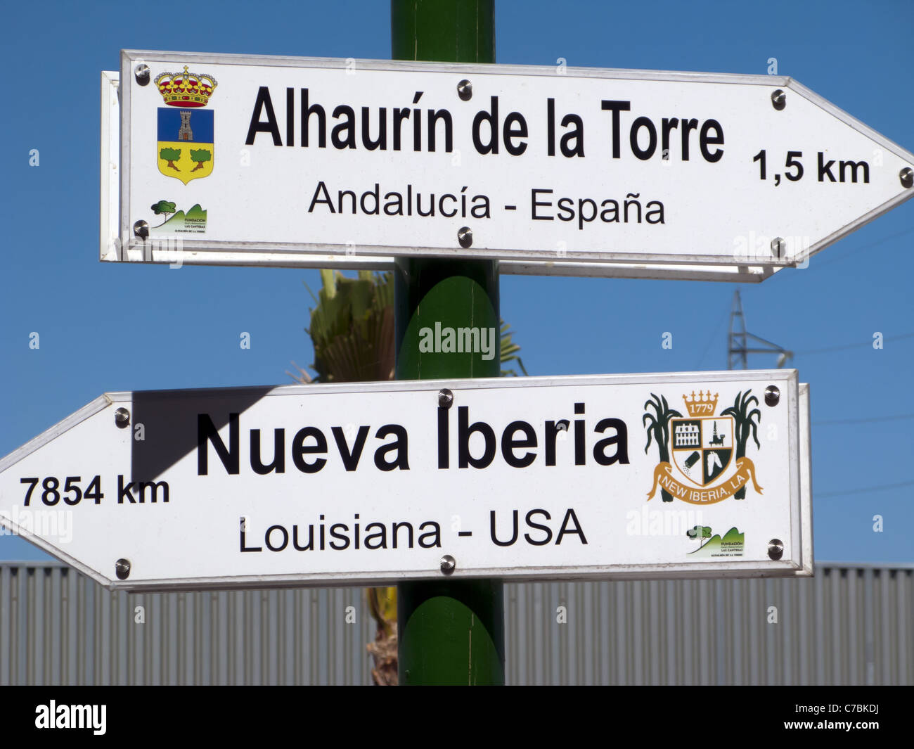 A direction sign pointing to New Iberia, Louisiana from Iberia Spain Stock Photo