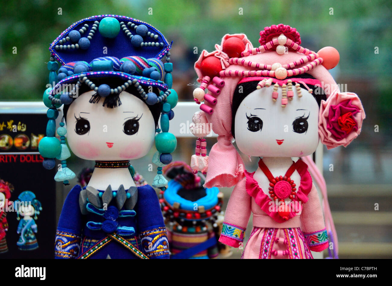 Dolls with colorful dresses and decorations. Sichuan, China. Stock Photo