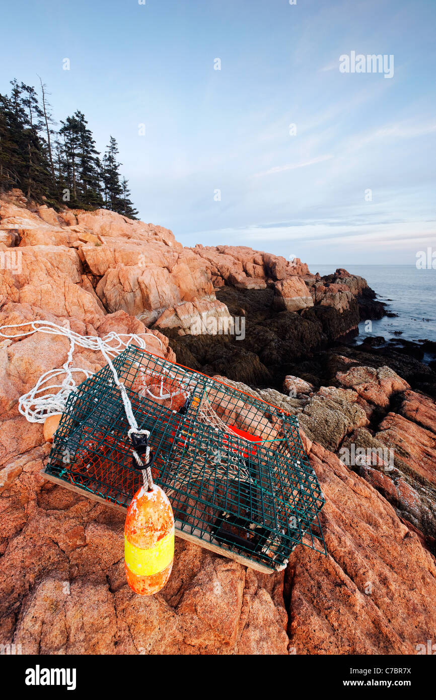 Lobster trap washed up on pink granite rocky shoreline, Mount Desert