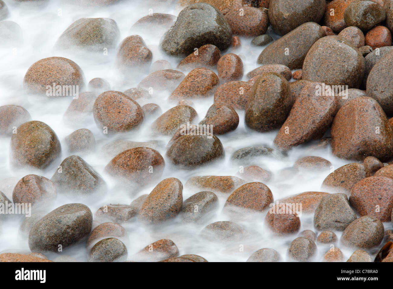 Water washing over round cobbles, Boulder Beach, Monument Cove, Acadia National Park, Maine, USA Stock Photo