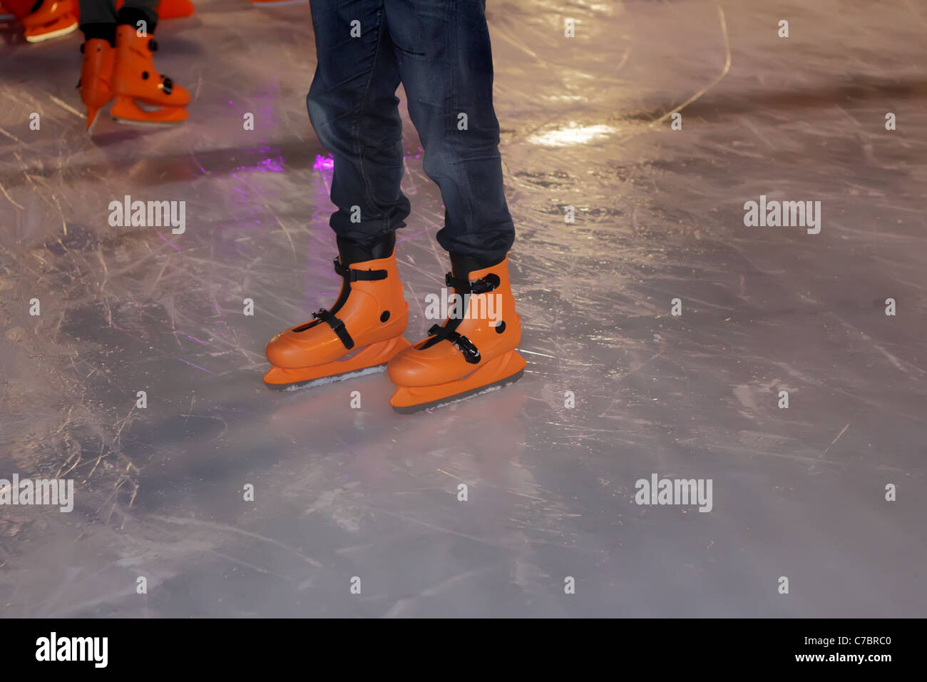 Legs with Ice Skating Shoes on Ice Ring Stock Photo