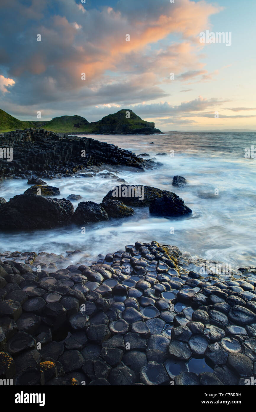 Waves splashing over basalt columns near sunset, Giant's Causeway ...