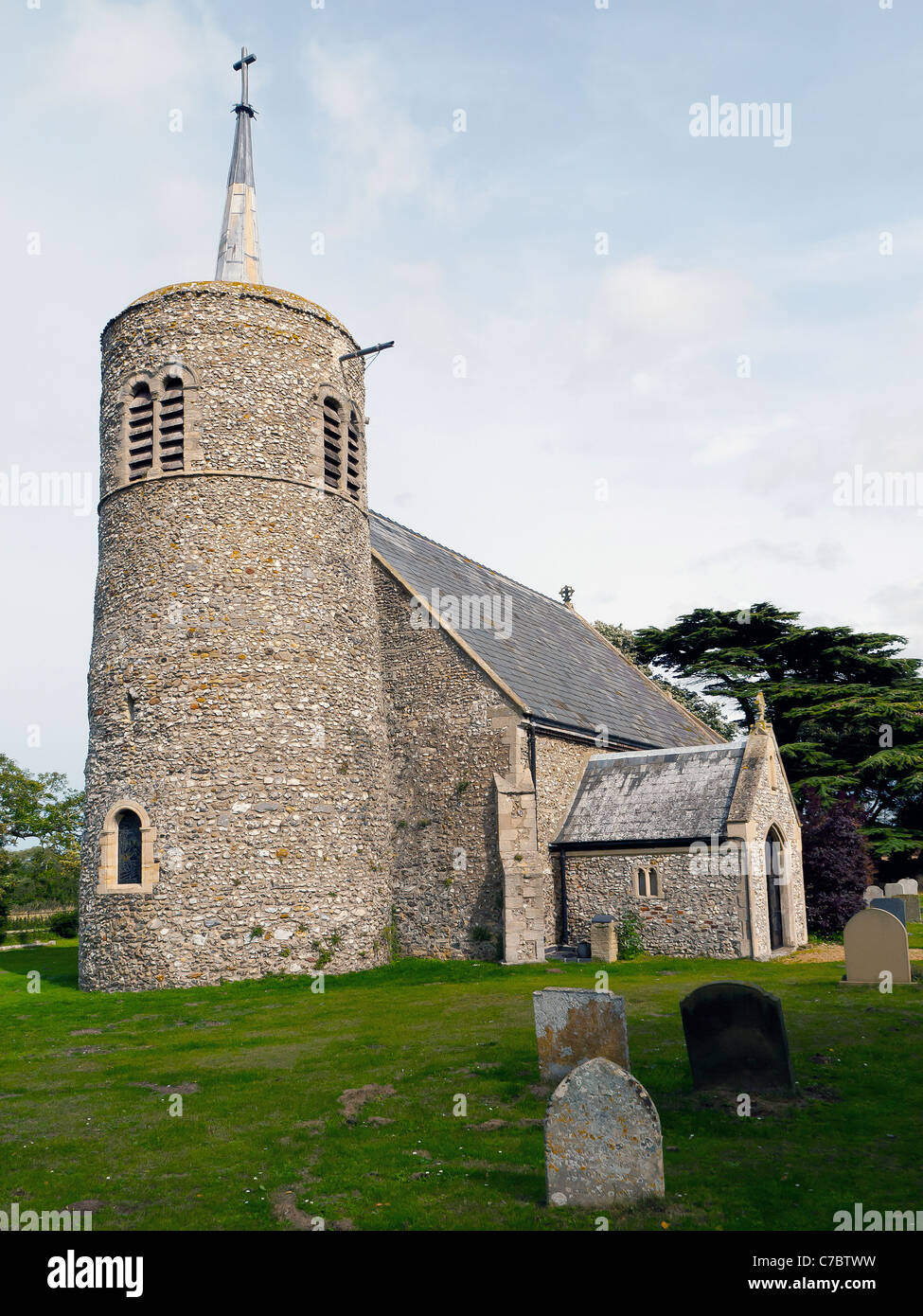 11th Century Church of Saint Mary the Virgin in Titchwell Norfolk stone built with a circular tower Stock Photo