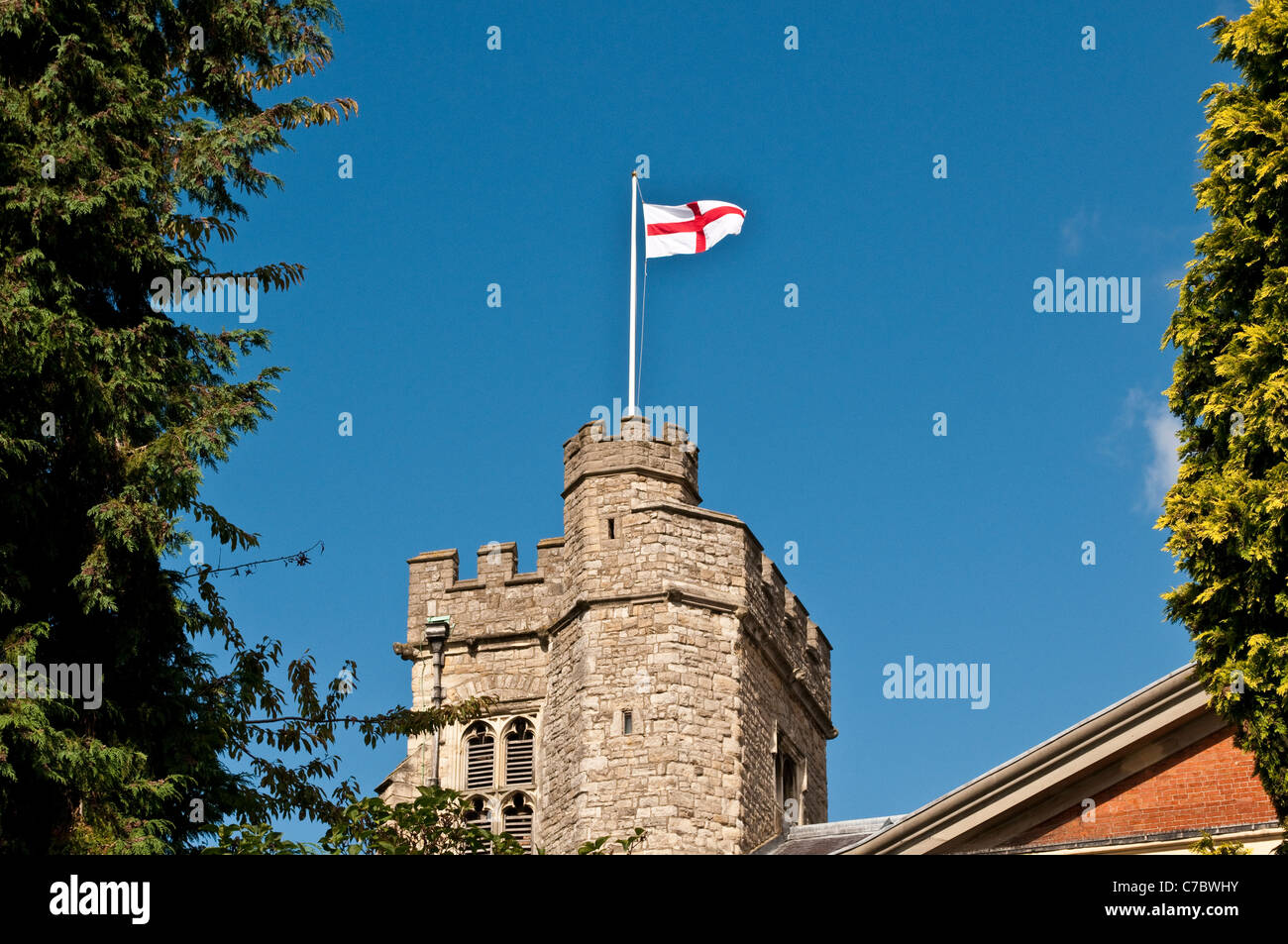 Union Jack waving in the wind on the tower of St Mary’s Parish Church, Twickenham, Middlesex, England, United Kingdom Stock Photo