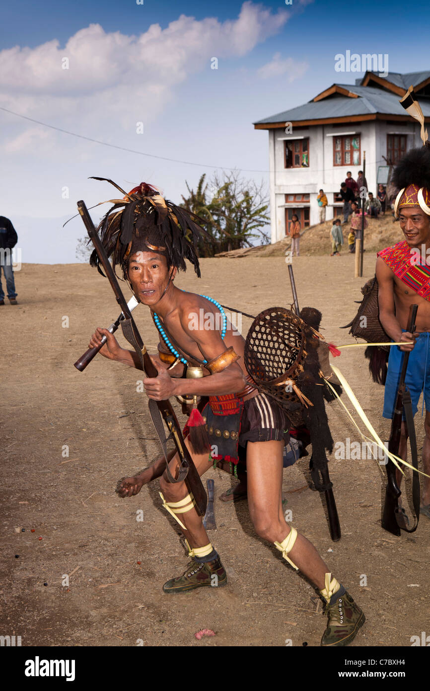 India, Nagaland, Longwa, Konyak Naga warriors in traditional dress in aggressive posture Stock Photo