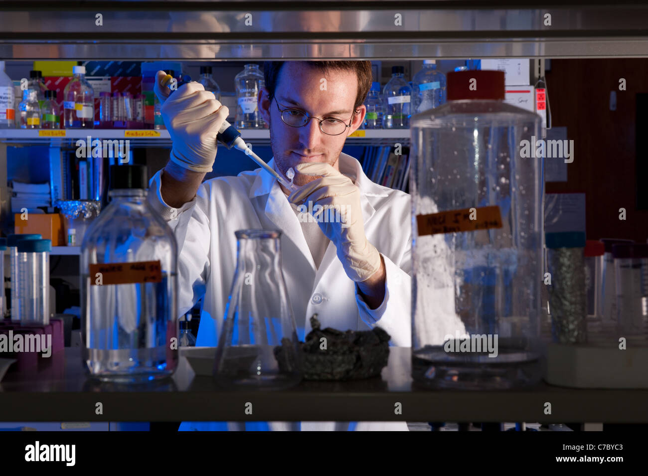 Scientist conducting experiment in lab Stock Photo