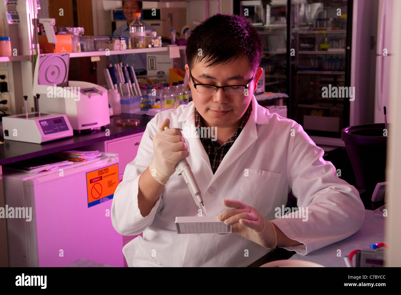 Scientist conducting experiment in lab Stock Photo