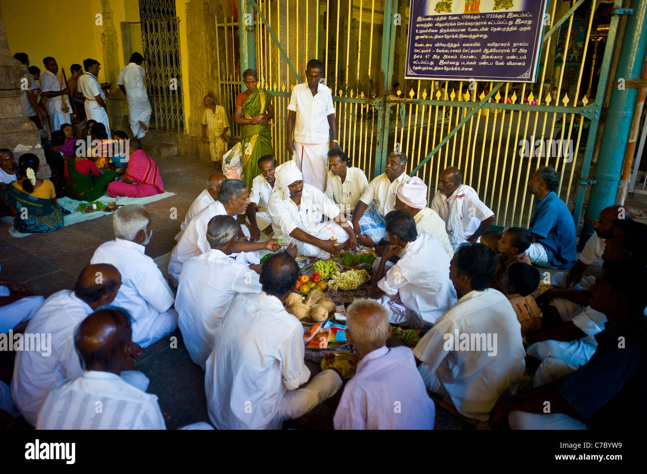 Hindu pilgrims have lunch in the Meenakshi Amman temple in Madurai, Tamil Nadu, India. Stock Photo