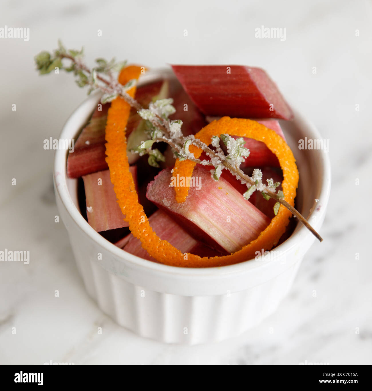 Chopped rhubarb in bowl garnished with orange peel and lavender sprig, by pastry chef Laurie Pfalzer, Pastry Craft Stock Photo