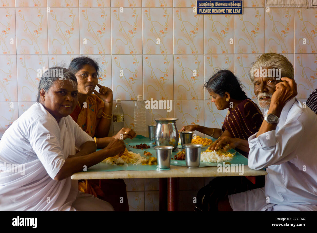 An indian family dining in a simple restaurant in Rameswaram, Tamil Nadu, India. Stock Photo
