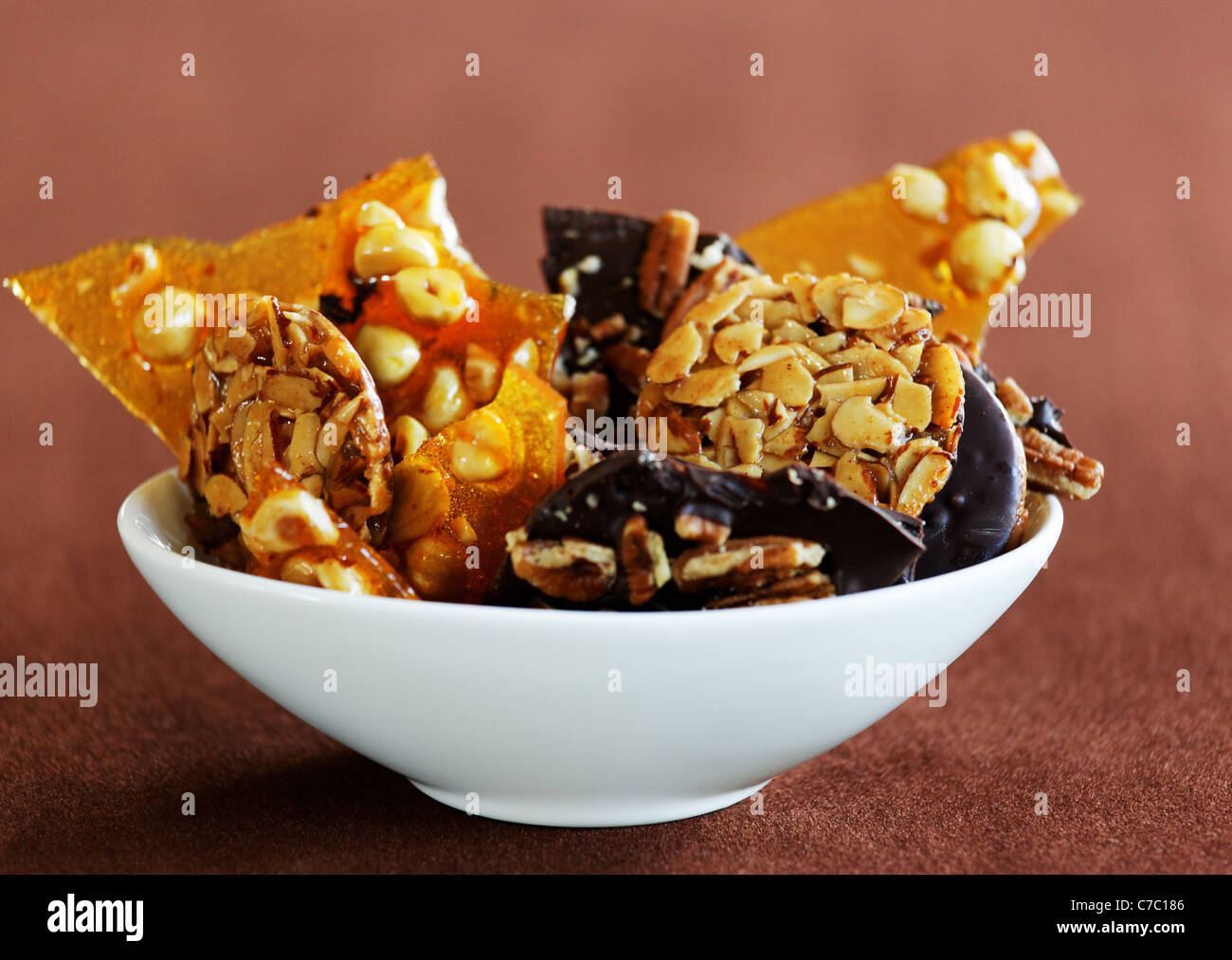 Hazelnut brittle, almond Florentines and chocolate pecan bark in a bowl, by pastry chef Laurie Pfalzer, Pastry Craft Stock Photo