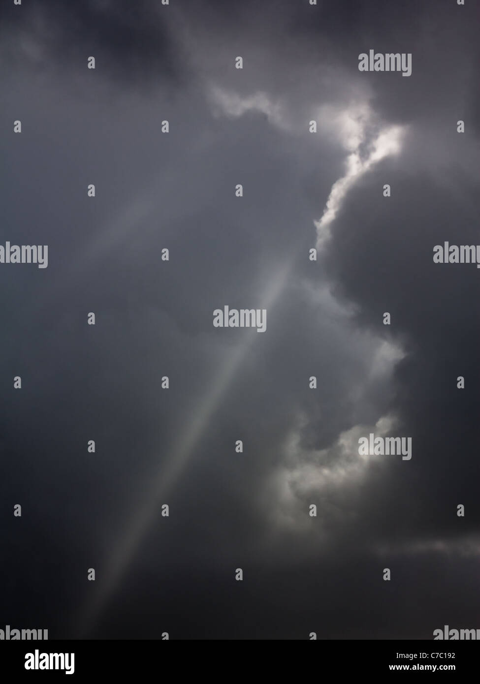 A shaft of light between storm clouds Stock Photo
