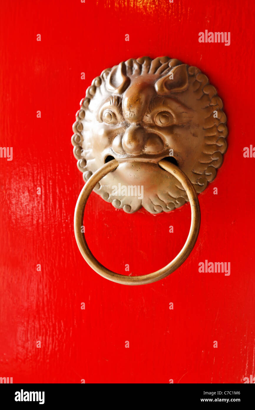 Door knocker on red door of temple in Po Fook Hill Cemetery, Sha Tin