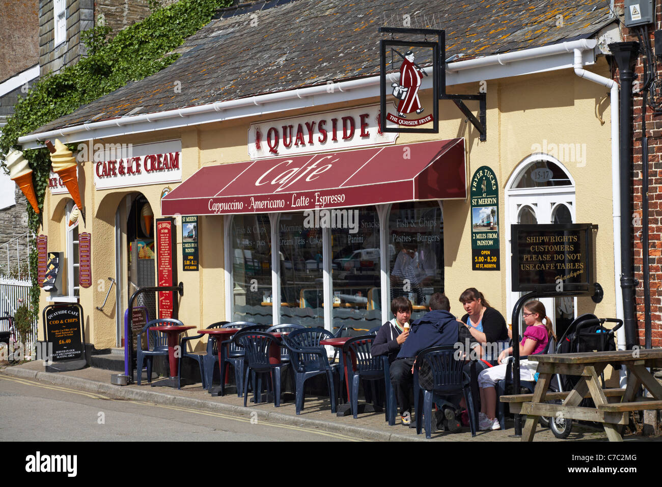 Family sat outside Quayside café eating ice creams at Padstow in May