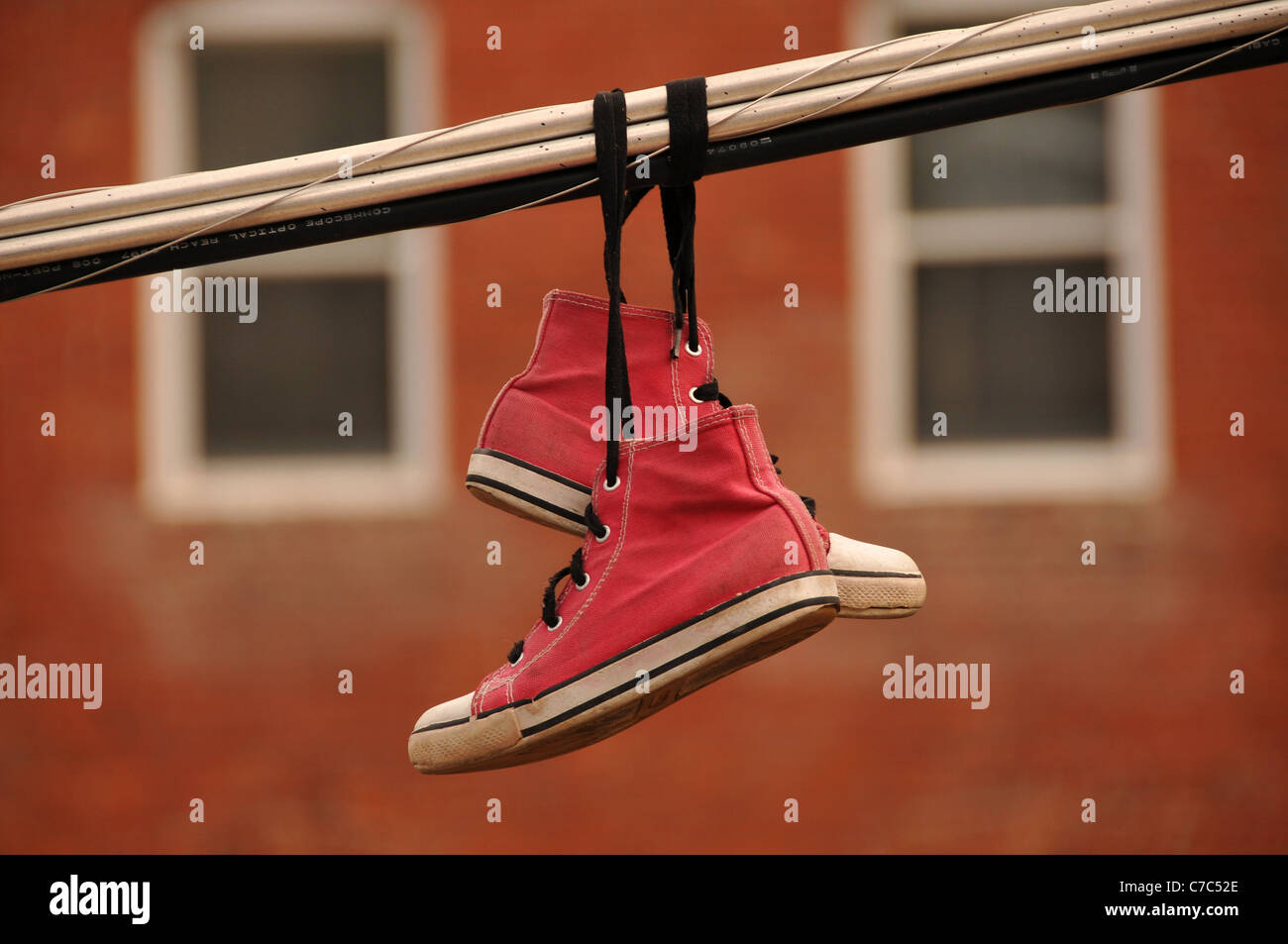 Pink high top canvas shoes hang from utility wires in Bisbee, Arizona