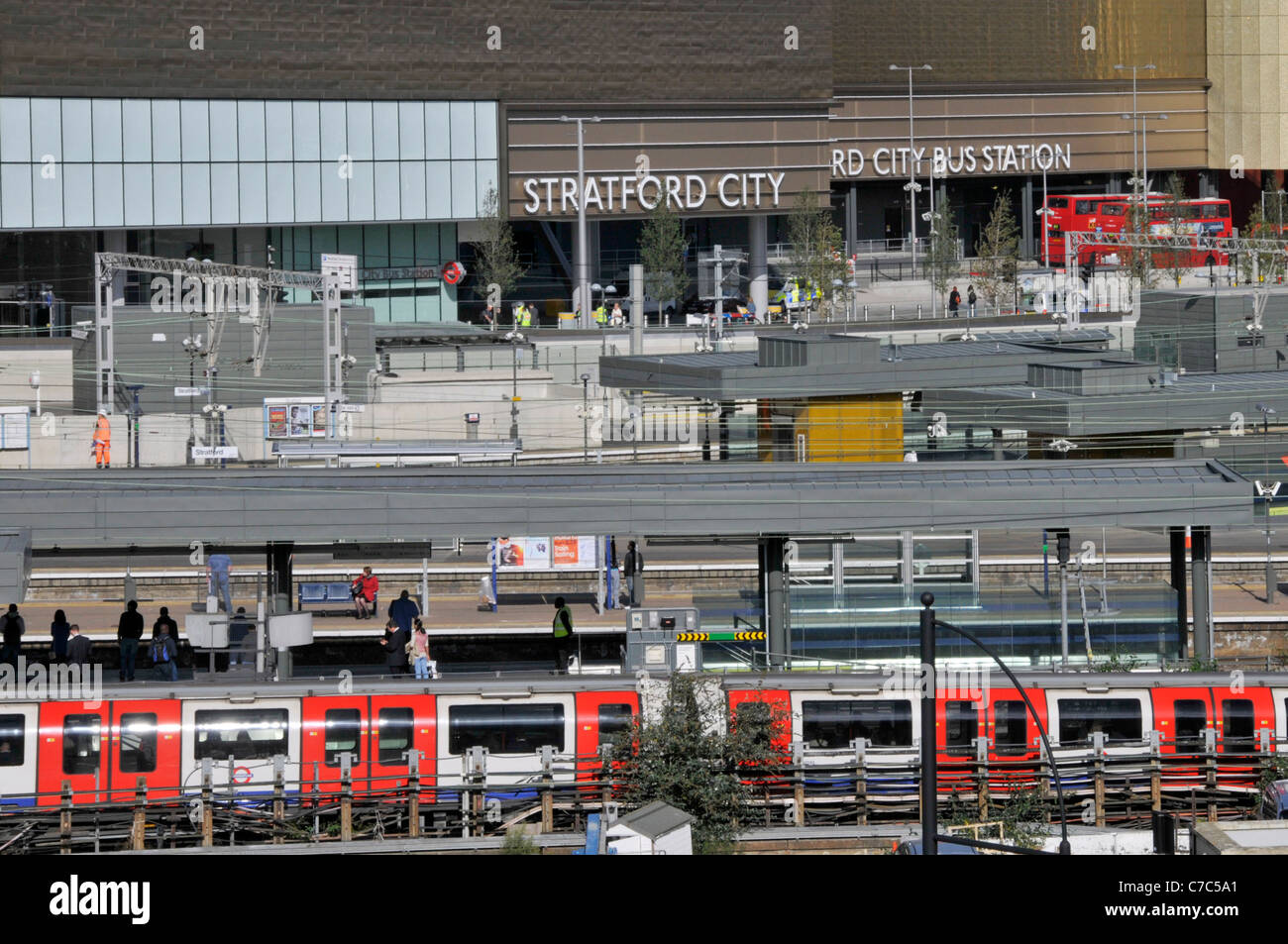 Stratford London railway station platform & trains includes Central line train & Stratford City Bus Station stop at Westfield shopping centre England Stock Photo