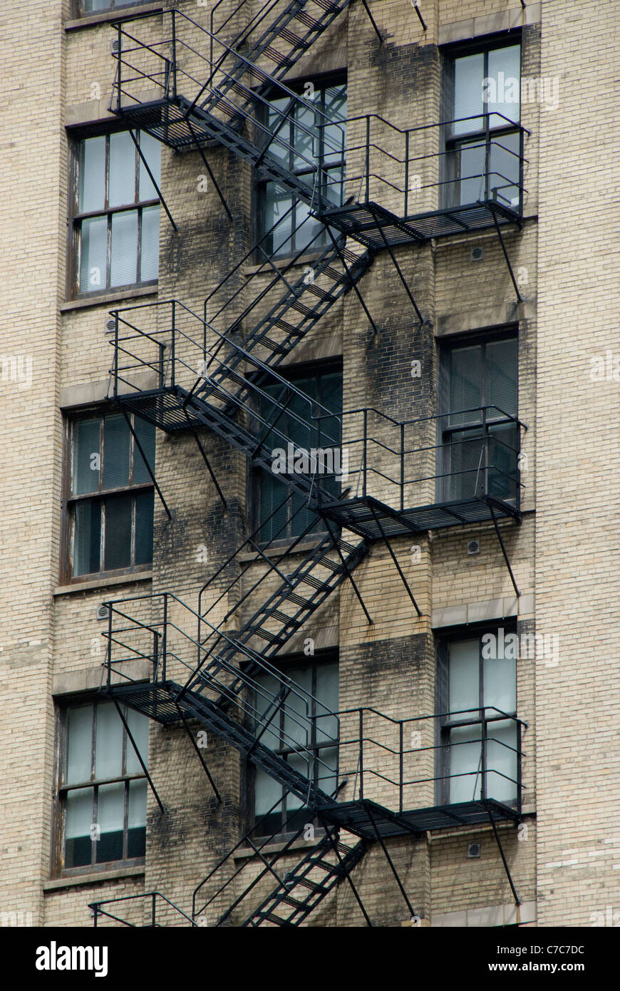 Fire escape walkup new york building. A tall building with a fire