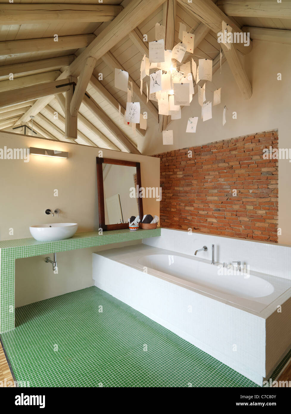 modern bathroom in the attic with wood ceiling and brick wall Stock Photo