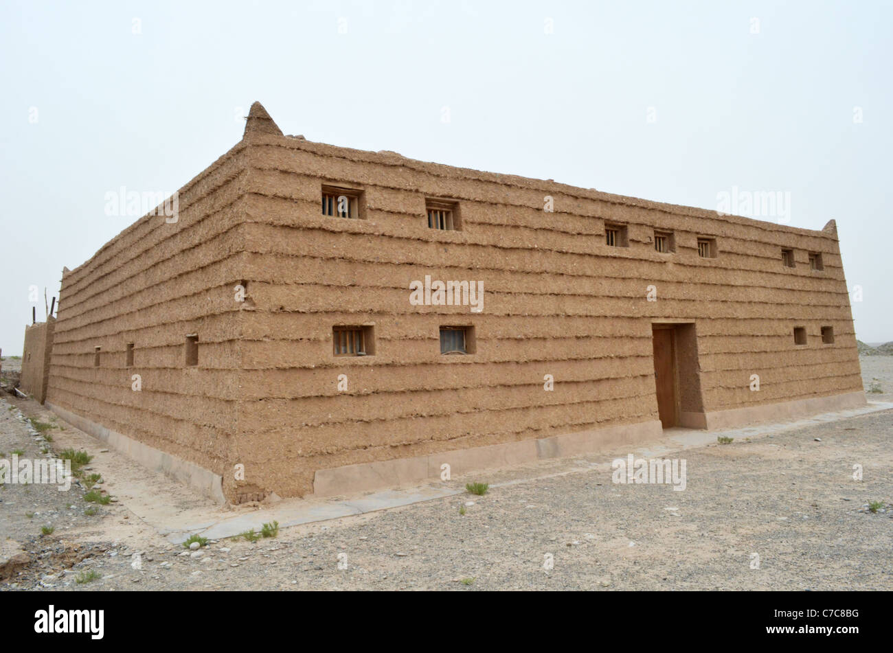 A modern house built in the traditional manner, using rammed earth layered with straw or reeds, Dunhuang, Gansu, China Stock Photo