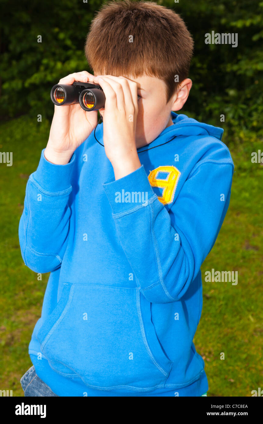 An eleven year old boy birdwatching with binoculars at Fairhaven