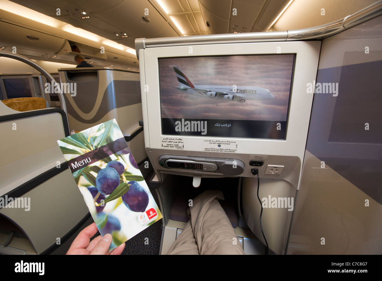UK, Business Class Air Travel, passenger looking at Menu on upper cabin of Emirates Airlines A380 aircraft Stock Photo