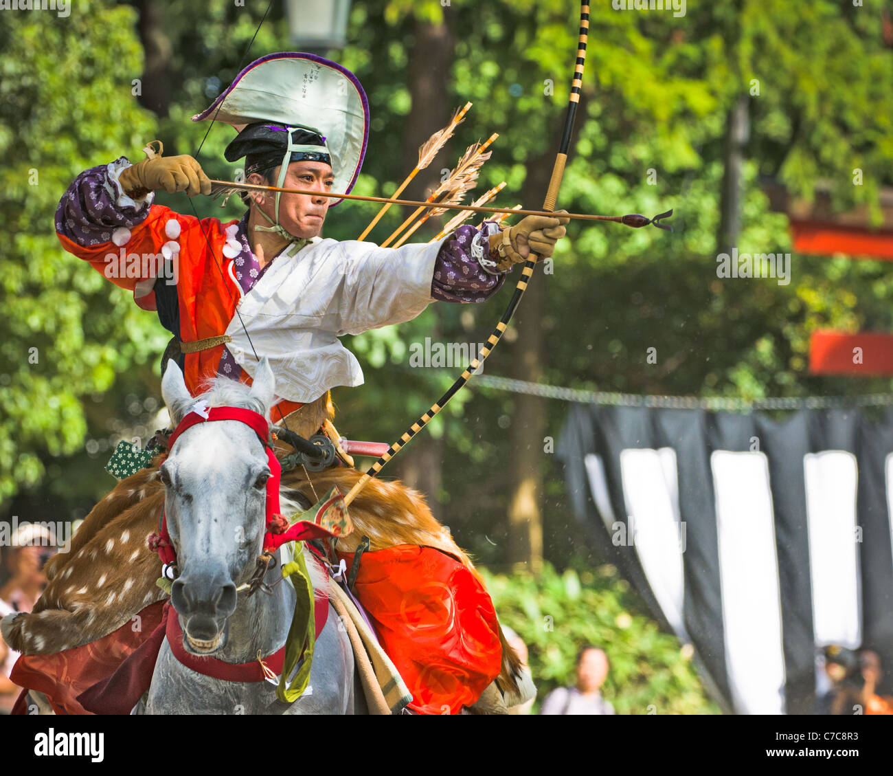 An Archer in Samurai Clothing prepares to shoot in a Horseback archery