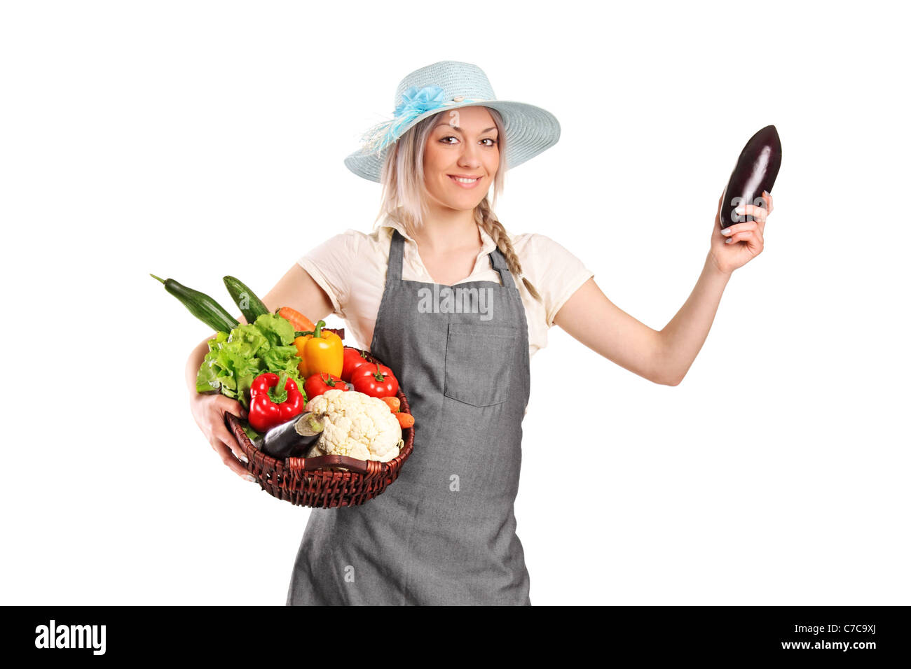 Full length portrait of a smiling female farmer holding various ...