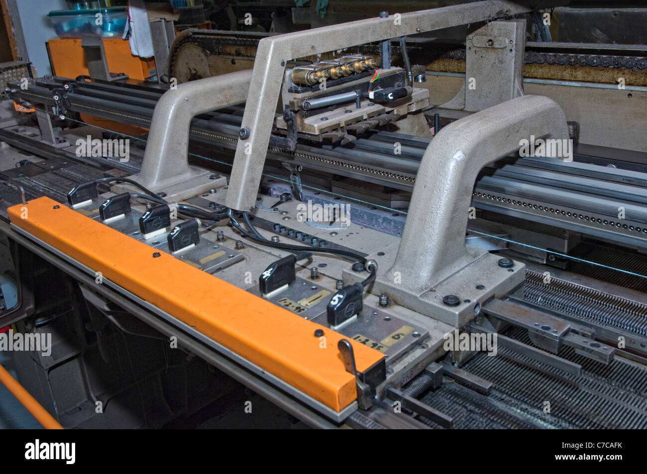 Carriage of an industrial flatbed knitting machine Stock Photo Alamy