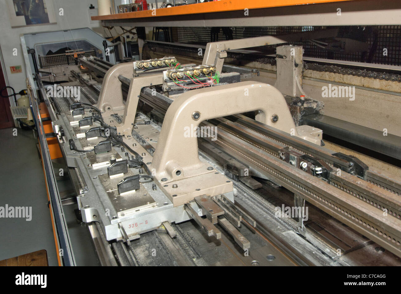 Carriage of an industrial flatbed knitting machine Stock Photo Alamy
