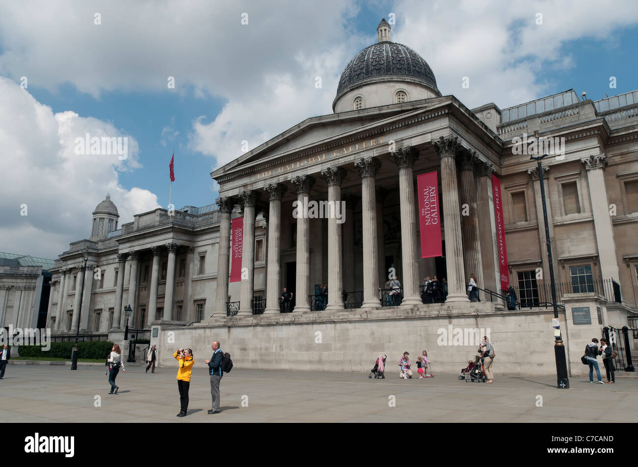 Tourists in front of the facade of the National Gallery, Trafalgar Square, London, England, United Kingdom. Stock Photo